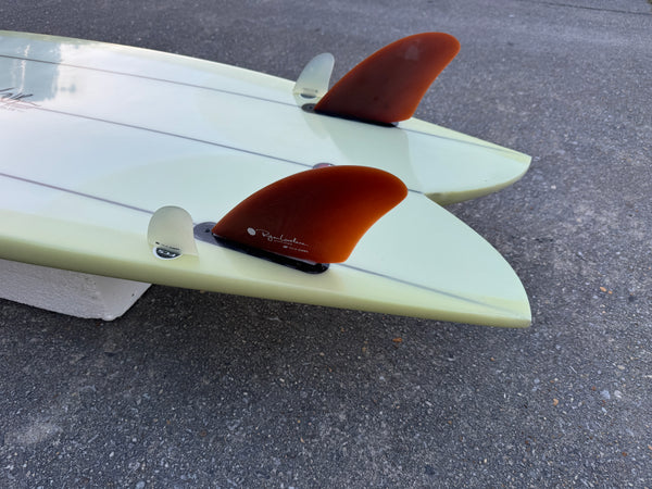 green triple stringer twin fin fish surfboard