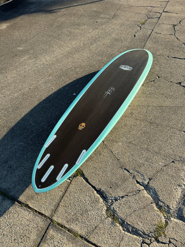 black and blue mid length 5 fin surfboard