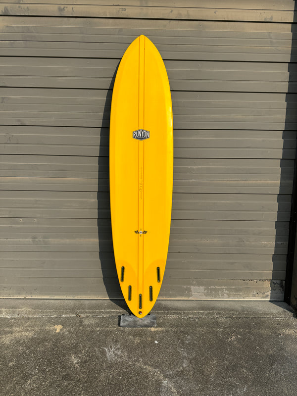 golden mid length surfboard