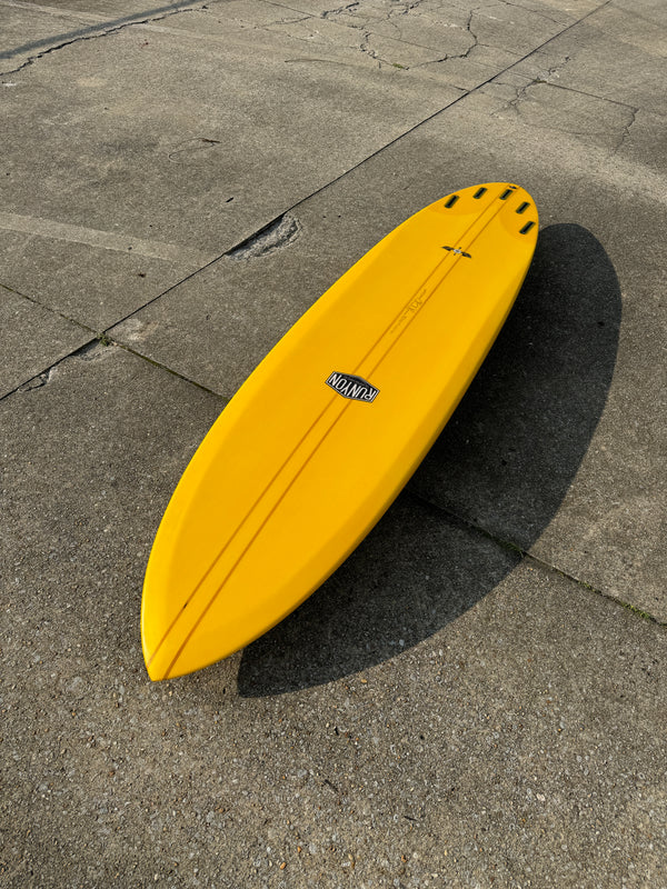 golden mid length surfboard