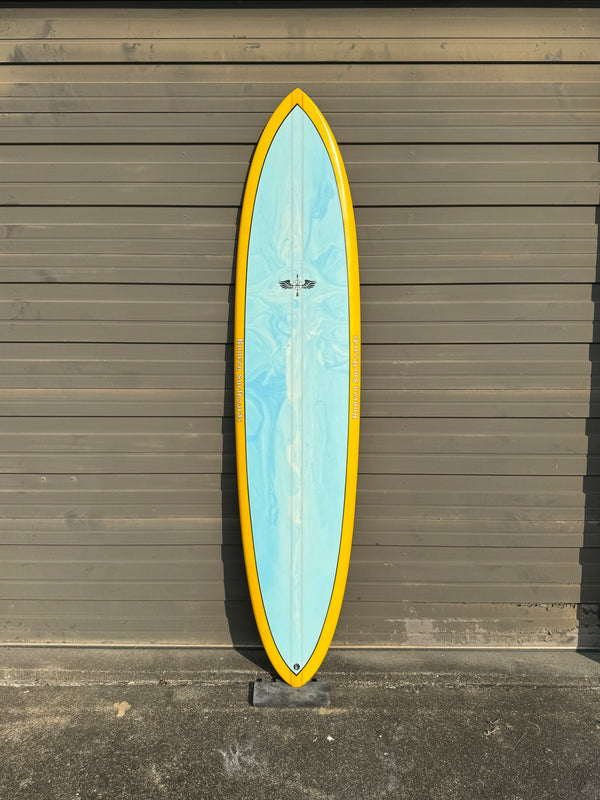 blue and yellow mid length surfboard