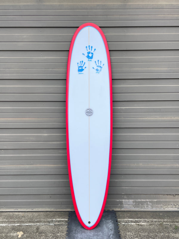 Red and white mid length surfboard with hand prints