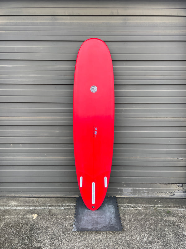 Red mid length surfboard