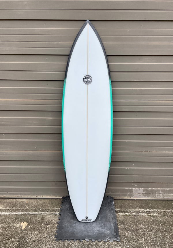 white and green shortboard surfboard