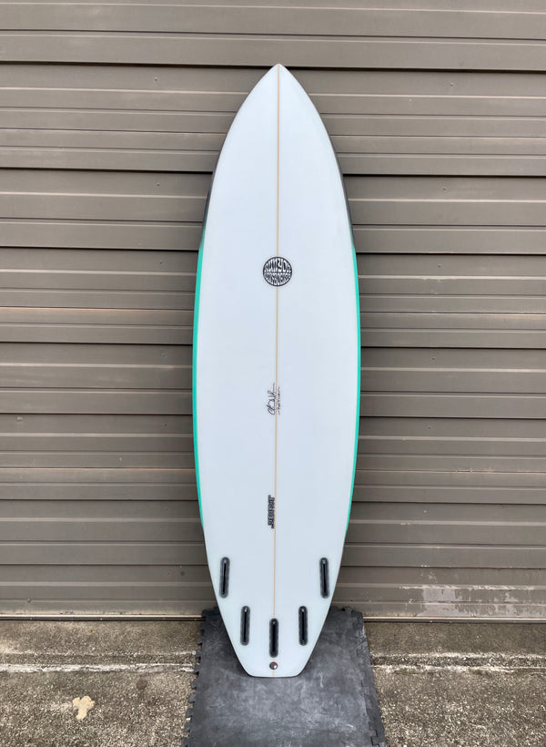 white and green 5 fin shortboard surfboard