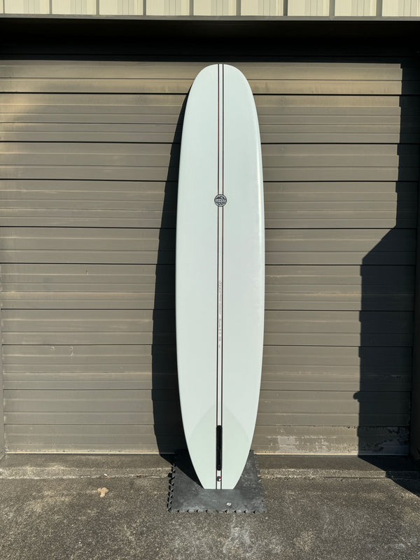 white and green longboard surfboard