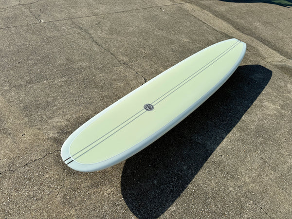 white and green longboard surfboard