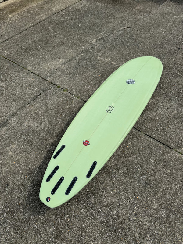 green mid length surfboard