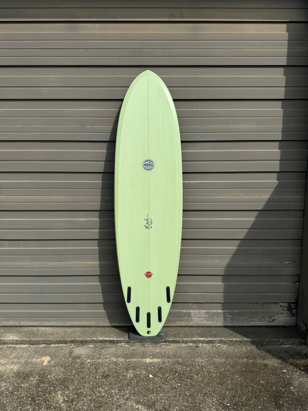 green mid length surfboard