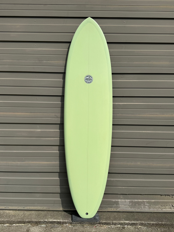 green mid length surfboard
