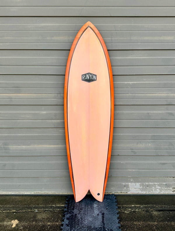 orange twin fin fish surfboard