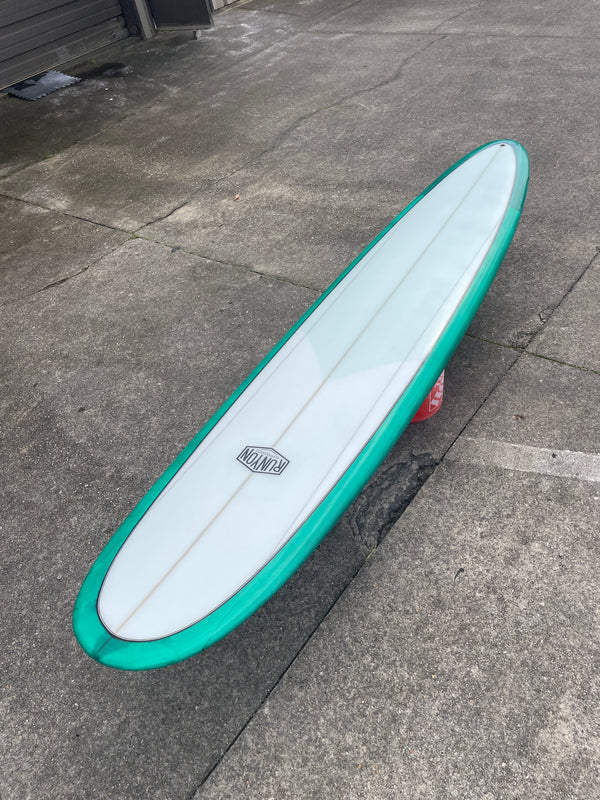 white and green longboard surfboard