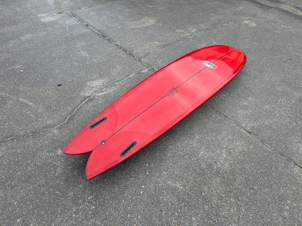 red mid length fish surfboard