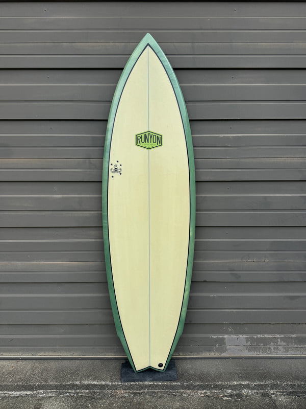 green and white swallow tail surfboard
