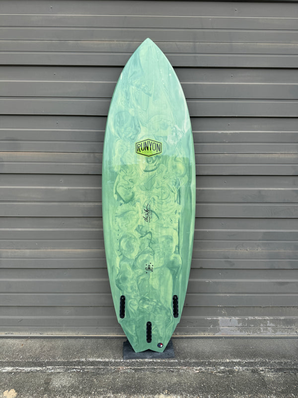 green and white swallow tail surfboard