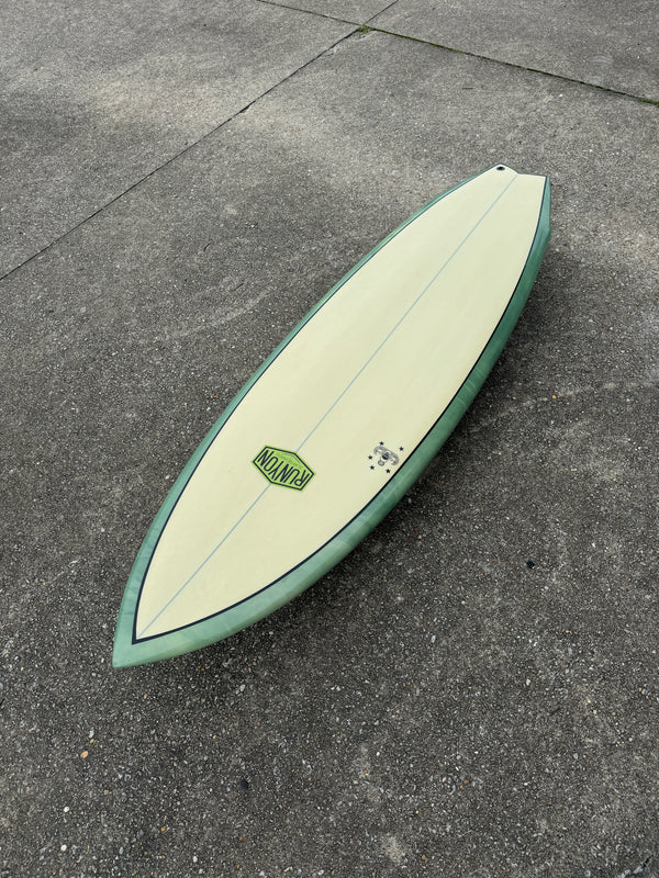 green and white swallow tail surfboard