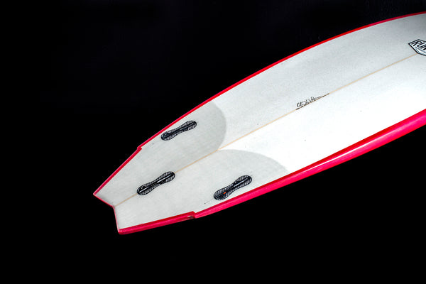 red and white swallow tail surfboard