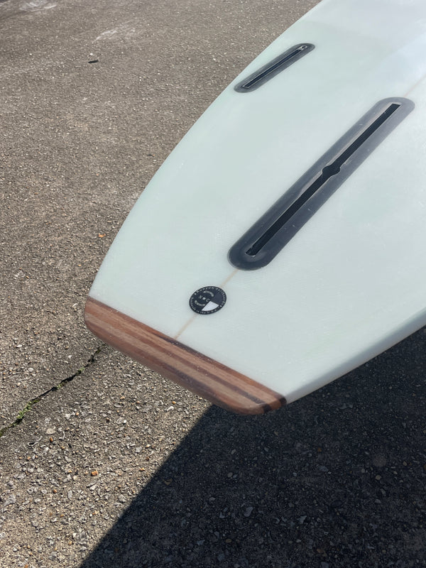 The end of a surfboard, Future Fin Boxes, Thruster Setup, Wooden Tail on surfboard.