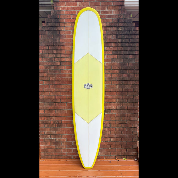 Yellow Rimmed Longboard standing against a brick wall. Single Stringer, Yellow Diamond
