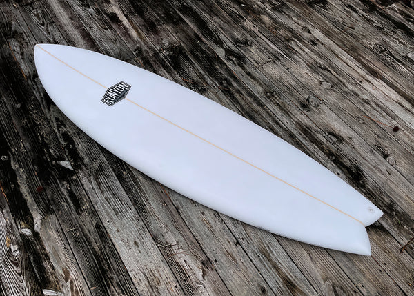 white shortboard swallow tail surfboard
