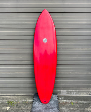 red mid length surfboard