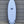 White surfboard leaning against sheet metal wall. Runyon Logo in the center. 4 +1 Future Fin Setup. Wider shortboard. 