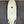 White, Asymmetric Mini Hammer Surfboard laying on its deck. 2 Fin Boxes on the left side of the fishtail, 3 fin boxes on the right. 
